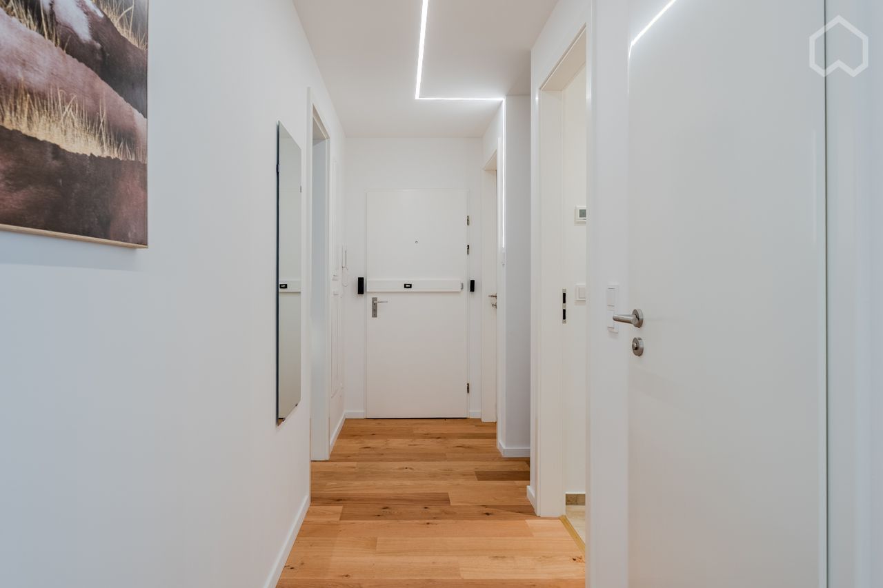 huge master bedroom with private balcony and working station in a high-end apartment