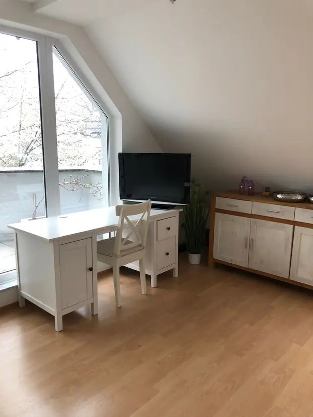 Bright, furnished 2-room top floor apartment with balcony & underground parking in Frankfurt Seckbach