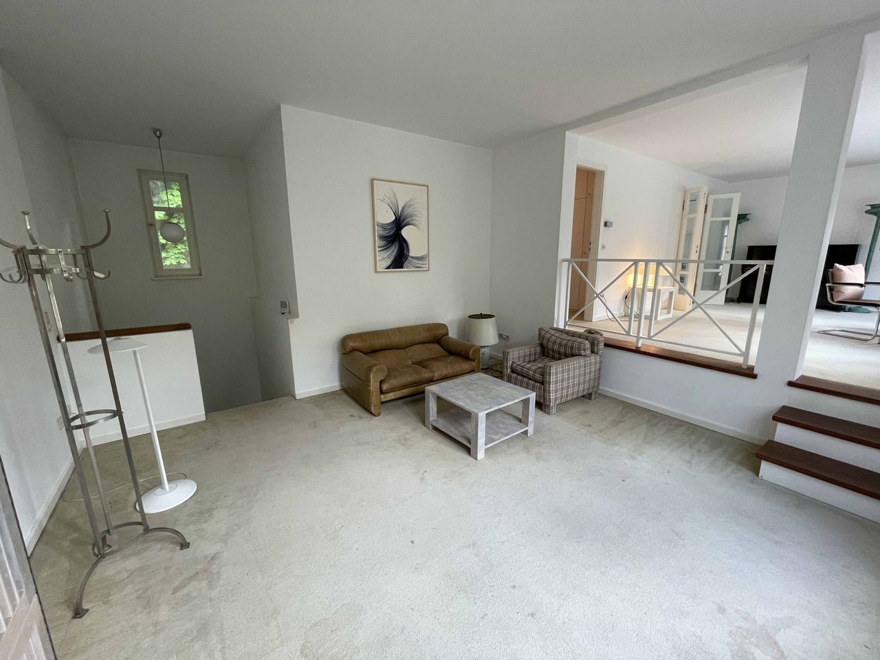 Light-flooded loft-like floor in 70s villa surrounded by trees